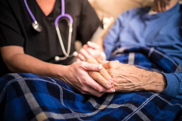 Healthcare professional compassionately caring for elderly patient